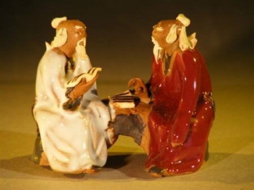 Ceramic FigurineTwo Men Sitting On A Bench - 2.5"Color: White & Red