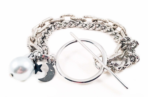 Silver bracelet with light blue pearl and black moon. Perfect for