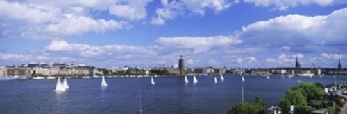 Sailboats in a lake with the city hall in the background  Riddarfjarde