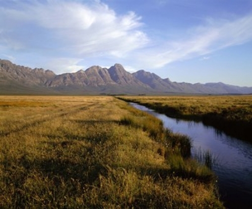 River with a mountain range in the background  Hermon Farm  outside of