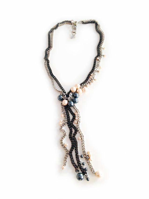 Lariat necklace with oversize pearls.