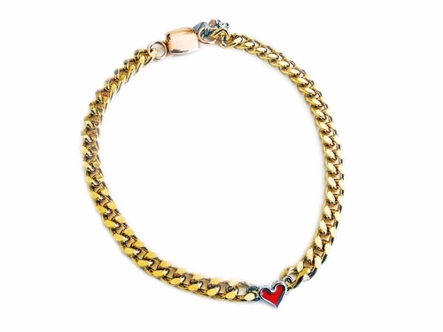 Gold chain necklace with red heart shaped charm.