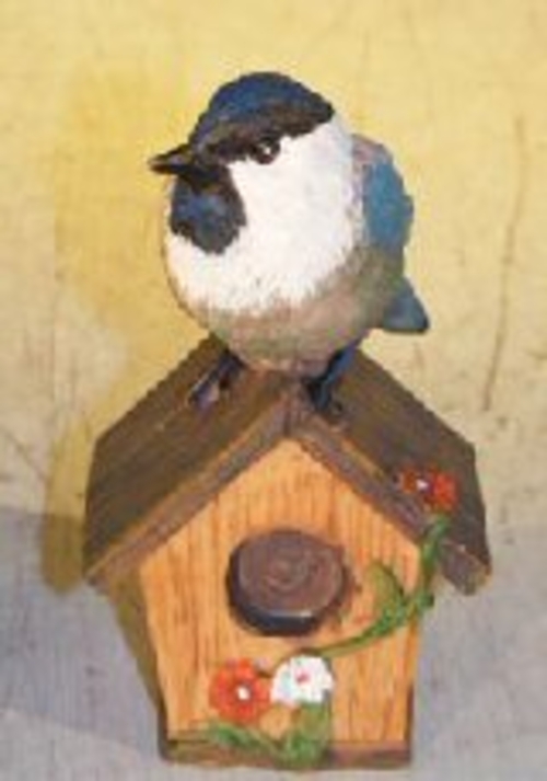 Miniature Bird FigurineSitting Atop A Bird House