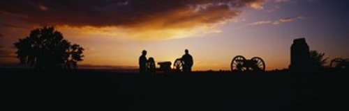 Silhouette of statues of soldiers and cannons in a field  Gettysburg N