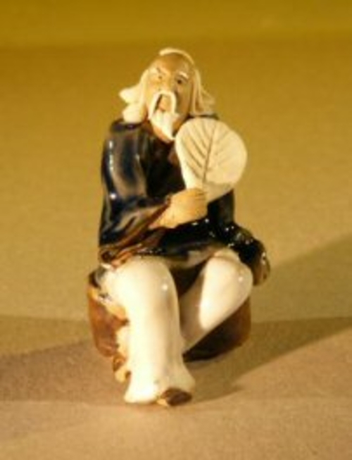 Miniature Figurine: Man Holding a Fan Sitting on a Rock - Blue Color -
