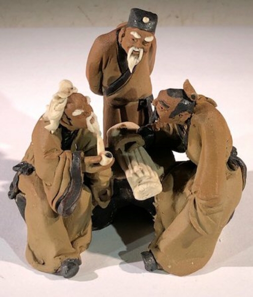 Miniature Ceramic FigurineThree Mud Men Sitting at a Table Playing