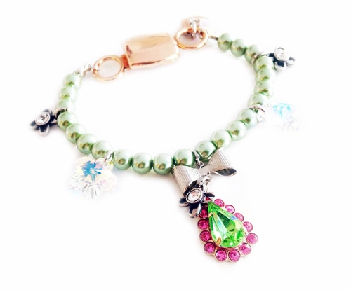 Light green beaded bracelet with pink and green rhinestones.